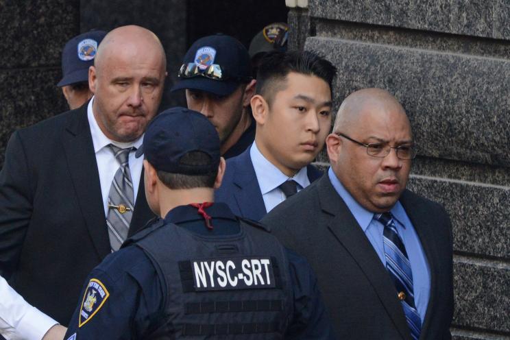 Peter Liang, center, leaves a courthouse earlier this year after avoiding a jail sentence for the killing of Akai Gurley.