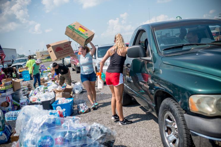 Volunteers help load Harvey victims cars with donated supplies in Port Arthur, Texas, on Sept. 2.