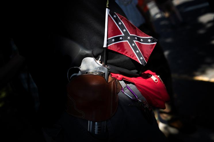 A man tucked a Confederate flag and gun into his belt while attending a protest organized by Tennessee based group "New Confederate State of America."