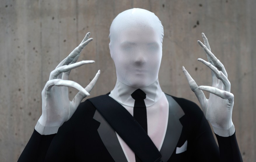 A fan cosplays as Slender Man.