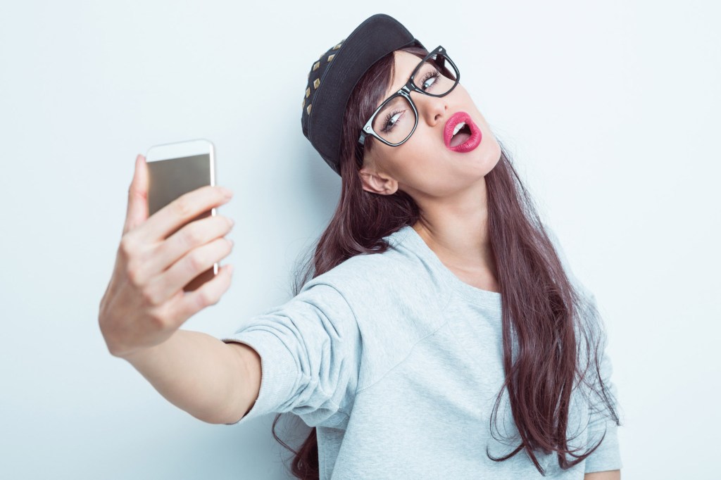 A young woman takes a selfie