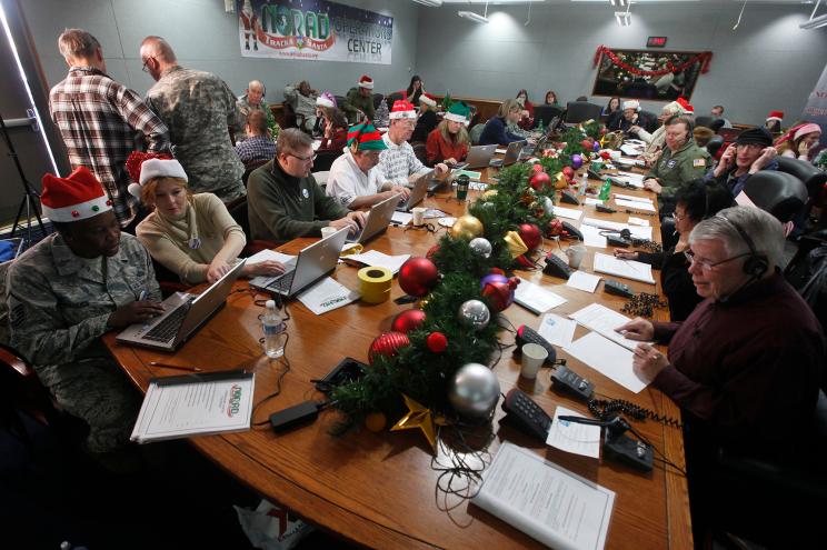 Volunteers take phone calls from children asking where Santa is during the annual NORAD Tracks Santa Operation.