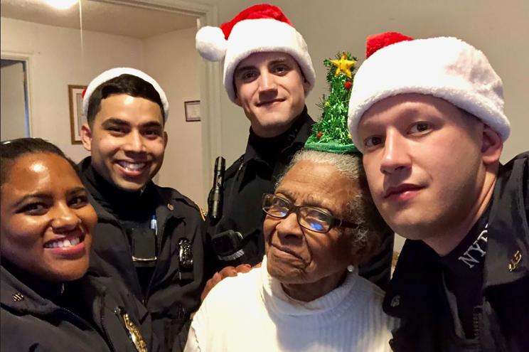 Cops visit Adriana Valoy (second from right), mother of slain cop Miosotis Familia