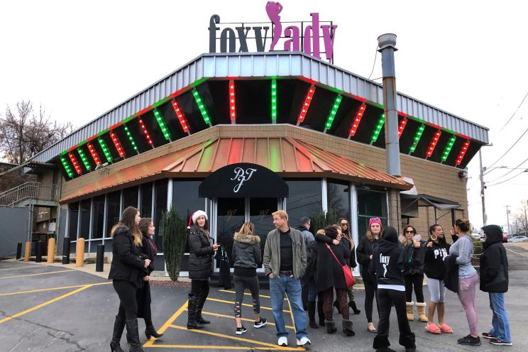 Former workers gather outside the Foxy Lady strip club.