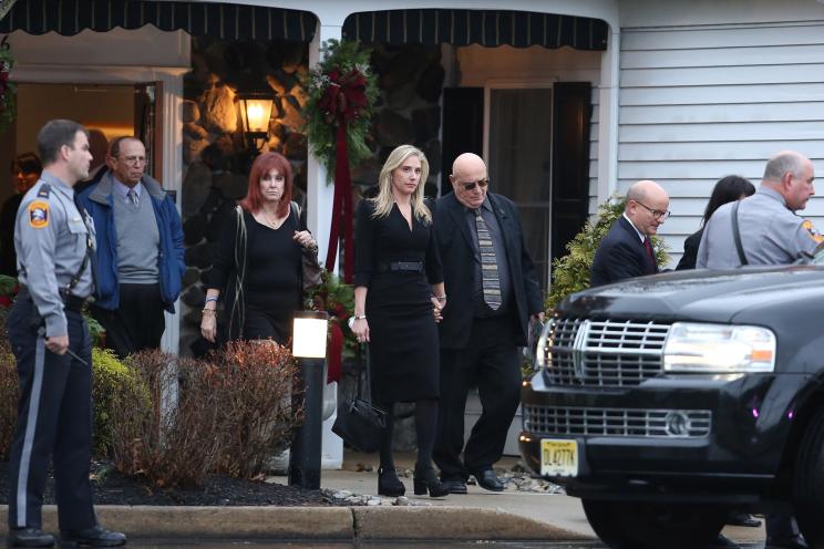 Bonnie Karidis (center, blonde hair) walks out of from the funeral service held for the NJ family killed in their mansion. Bonnie is the sister of one of the victims, Jennifer Karidis Caneiro.