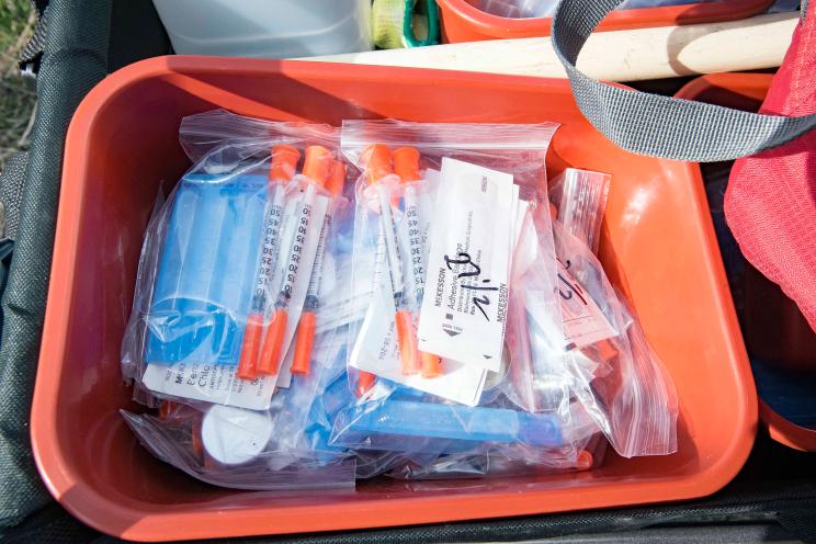 A cart of new syringes.