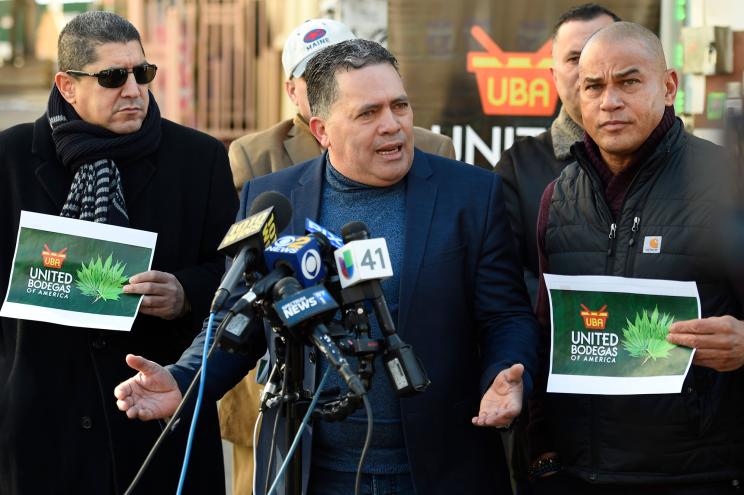 Radames Rodriguez (center) and Fernando Mateo (right) speak at the United Bodgeas of America press conference on allowing bodegas to sell marijuana when legalized