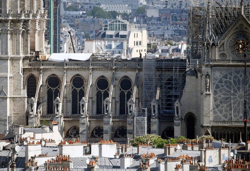 Temporary tarpaulins are installed on the roof of the Notre-Dame cathedral to protect it from rain damage.