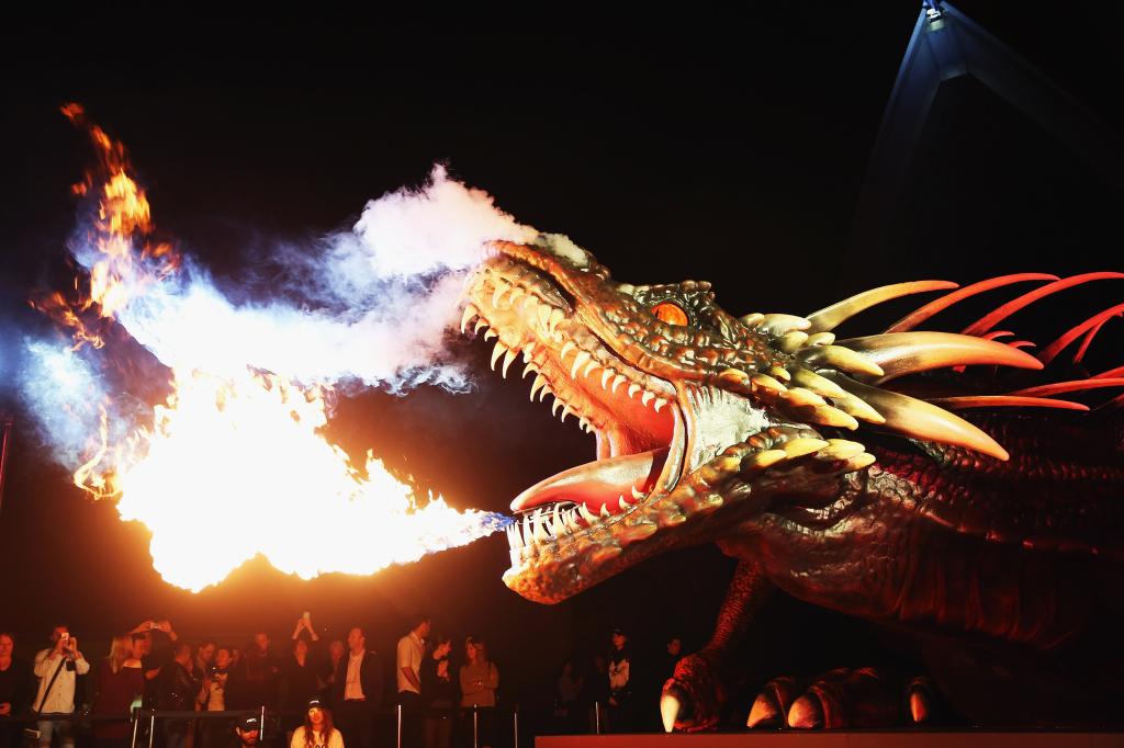 SYDNEY, AUSTRALIA - APRIL 13:  A dragon statue emits fire as people look on the Sydney premiere of "Game Of Thrones" at Sydney Opera House on April 13, 2015 in Sydney, Australia.  (Photo by Don Arnold/WireImage)