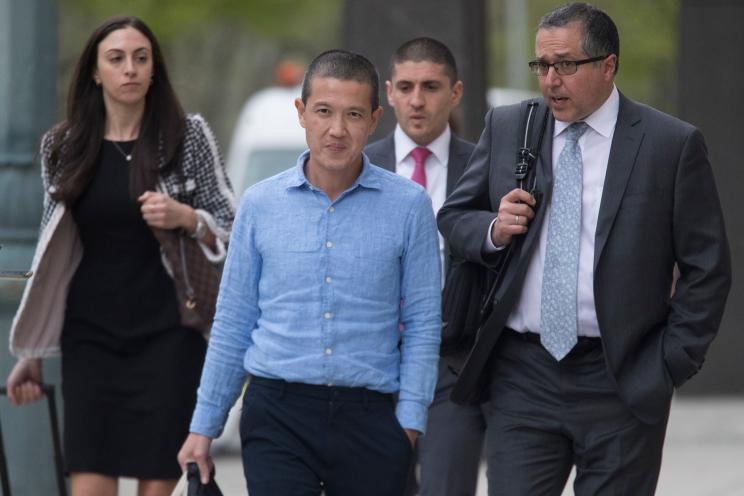 Former Goldman Sachs executive Roger Ng (center) leaves Brooklyn federal court with attorney Marc Agnifilo (right).