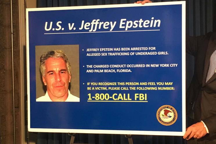 A billboard used during the FBI's press conference announcing charges against Jeffrey Epstein. It reads: "If you recognize this person and feel you may be a victim, please call 1-800-CALL-FBI."