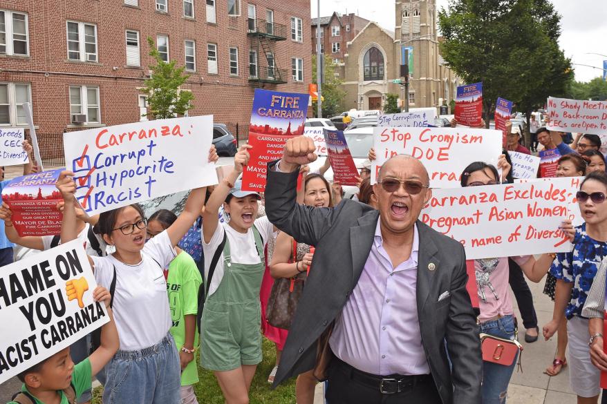 Asian Americans protesting Richard Carranza, holding signs claiming he is racist.