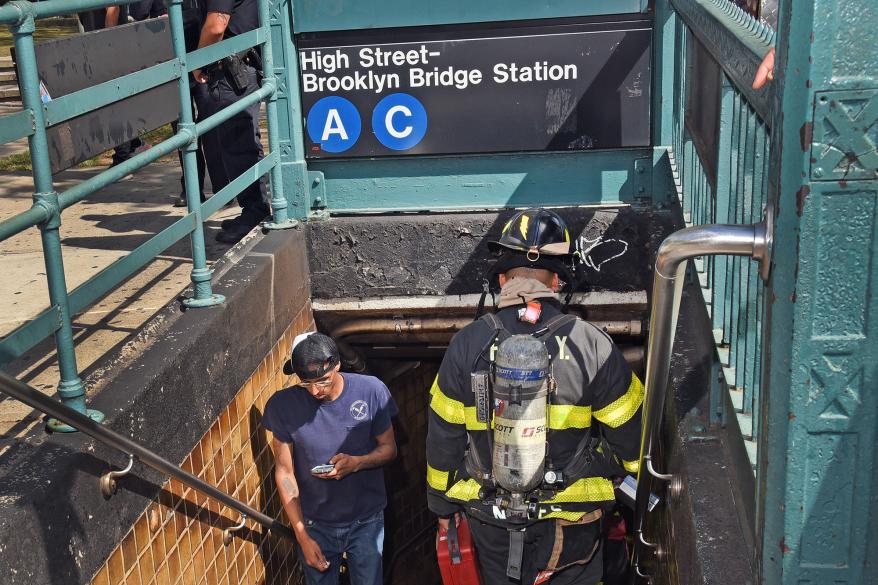 FDNY firefighters enter the Brooklyn Bridge A C train station to help with an evacuation