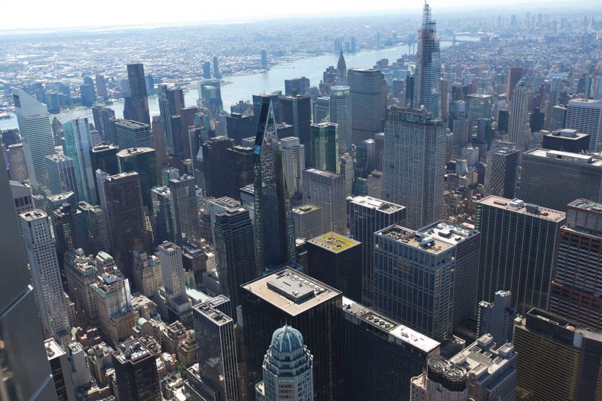 This southeastern view captures Midtown's skyscrapers, including the Chrysler Building and Rockefeller Center, as well as under-construction One Vanderbilt and the MoMA tower.