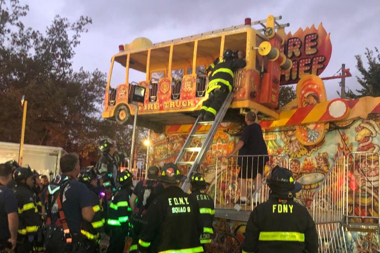 Proving the FDNY leaves no smoke-eater behind, New York's Bravest rescued four people who were trapped in a fire-truck ride at Staten Island's Holy Trinity Church Greek Festival.