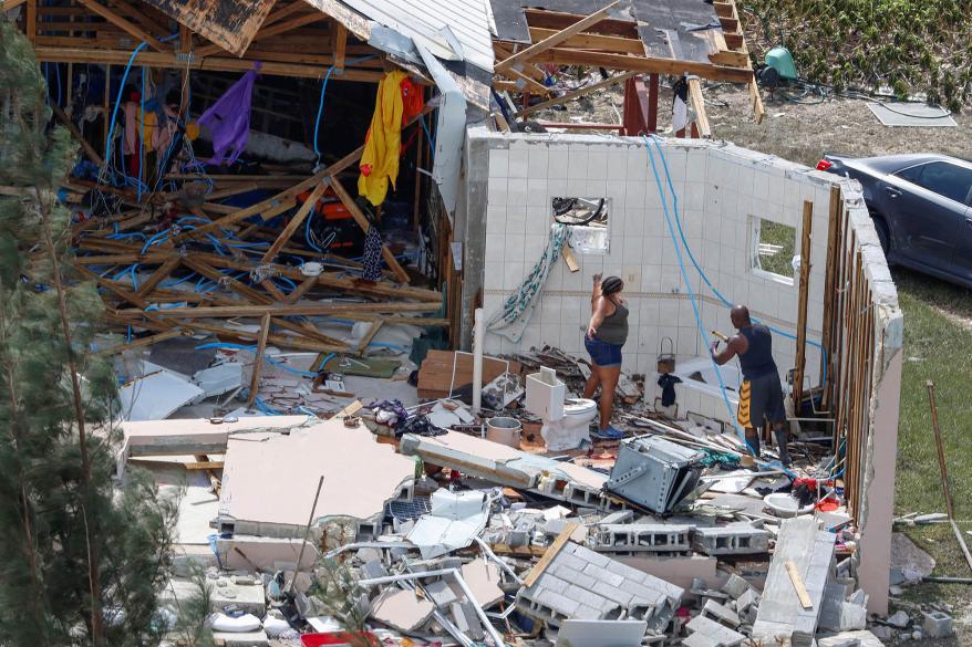 Residents look through debris following Hurricane Dorian in the Bahamas.