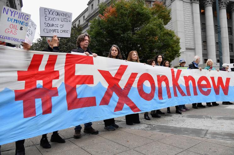 Climate activists protest on the first day of the ExxonMobil trial outside the New York State Supreme Court building