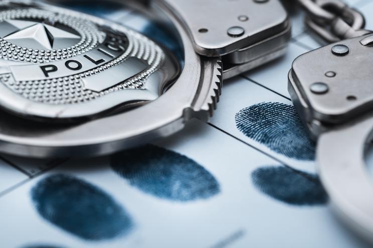 Handcuffs on top of a set of fingerprints