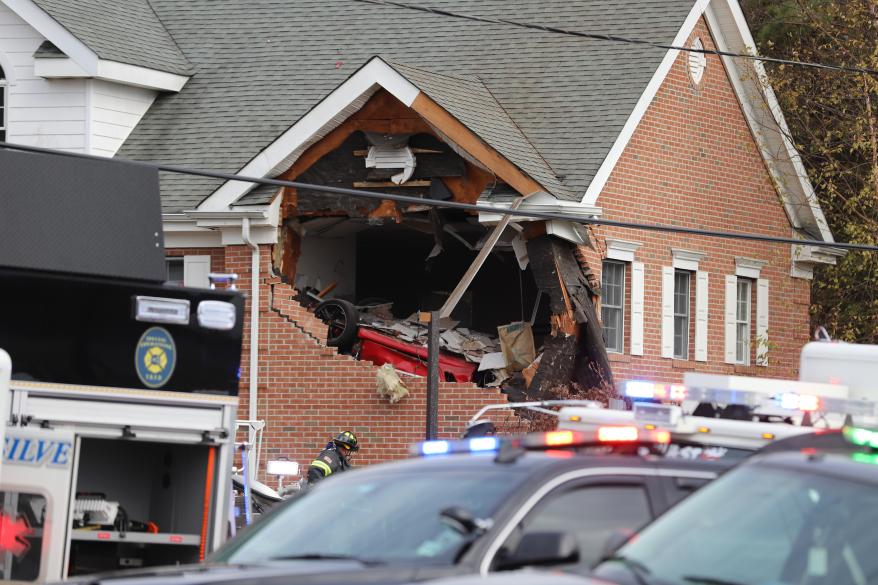 Authorities at the scene where a Porsche crashed into the second floor of a New Jersey building.