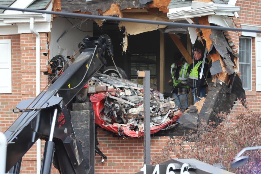 The car being removed from the building.