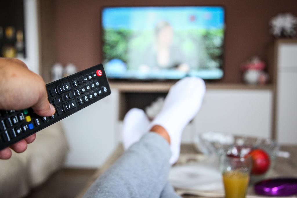 Person watching TV in living room.