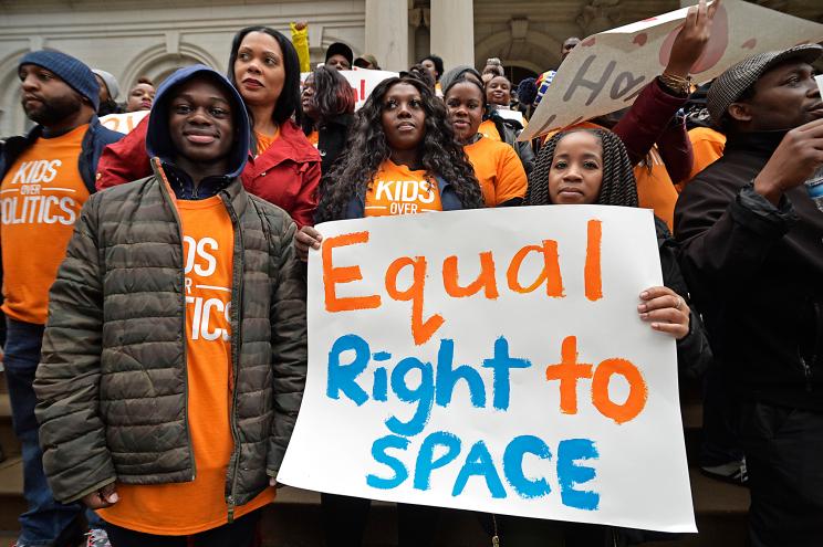 Success Academy parents stand on the steps of NYC's City Hall