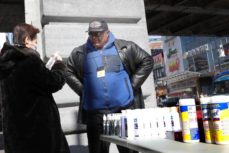 Street Vendor Samuel Hopkins a selling Hand sanitizers, Lysol and masks at the Corner of Main Street and 41st Avenue in Flushing, Queens.