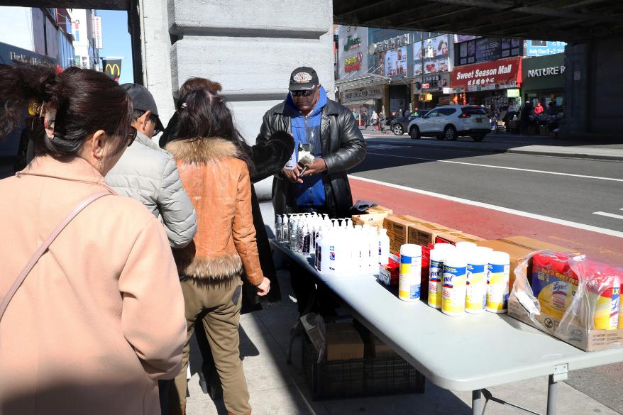 Street Vendor Samuel Hopkins sells hand sanitizer, Lysol and masks at the corner of Main Street and 41st Avenue in Flushing, Queens.