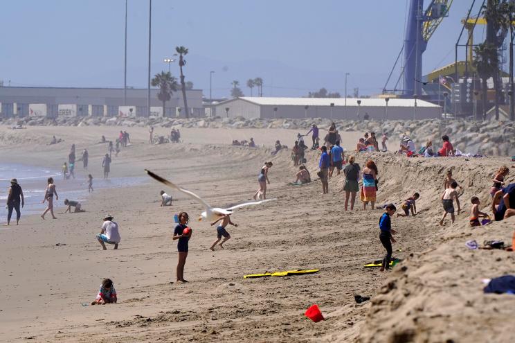 People hang out at Port Hueneme Beach in California on Thursday.