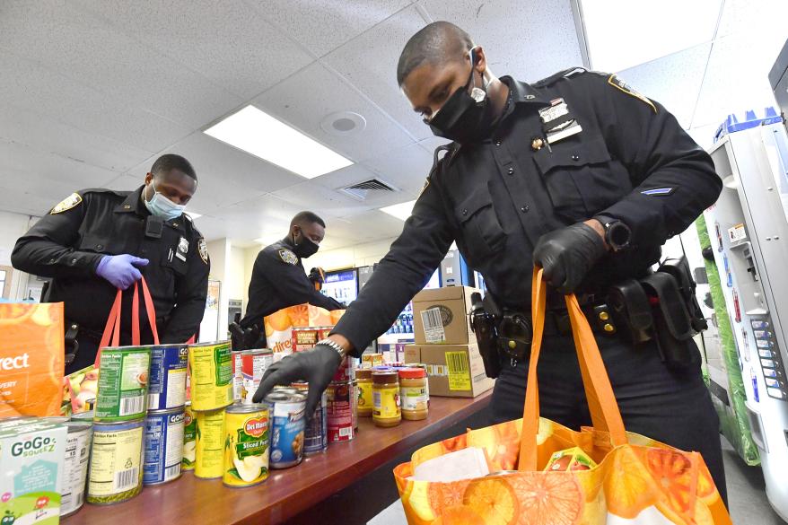 Cops from the 73rd Precinct command in Brownsville, Brooklyn deliver food to their community