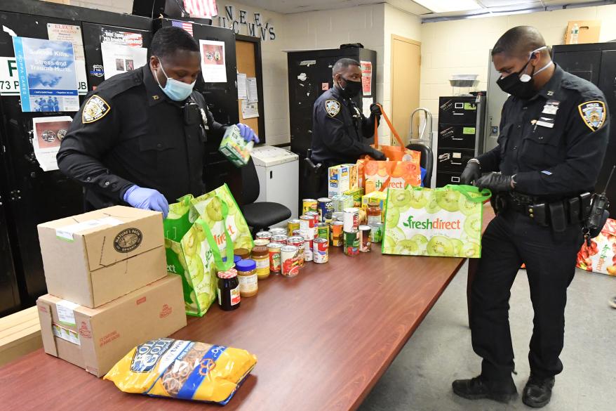 Cops from the 73rd Precinct command in Brownsville, Brooklyn deliver food to their community