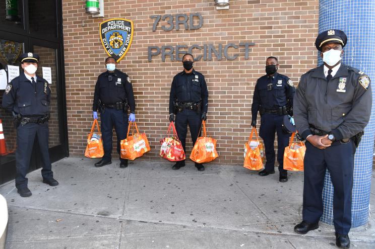 Cops from the 73rd Precinct command in Brownsville, Brooklyn deliver food to their community