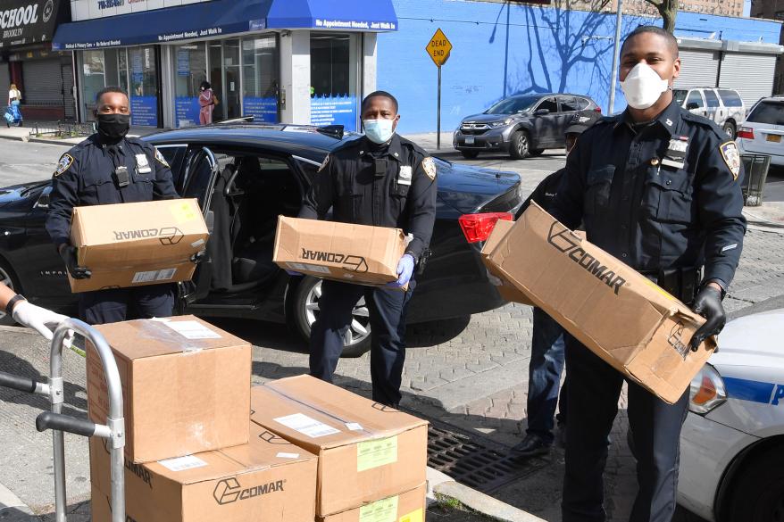 Cops from the 73rd Precinct command in Brownsville, Brooklyn deliver food to their community