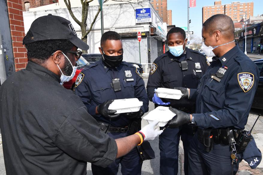 Cops from the 73rd Precinct command in Brownsville, Brooklyn deliver food to their community