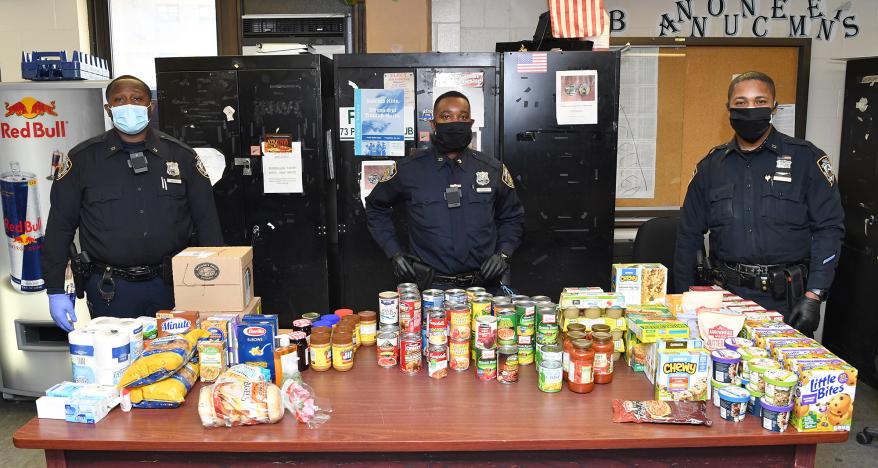 Cops from the 73rd Precinct command in Brownsville, Brooklyn deliver food to their community