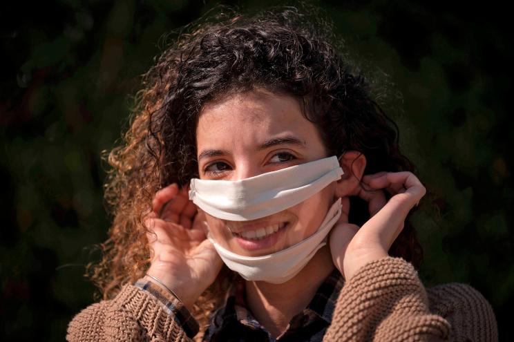 French entrepreneur Anissa Mekrabech wears a transparent protective face mask she created for the deaf and hearing-impaired people. She recently launched a crowdfunding appeal to develop an "inclusive" mask allowing lip-reading for deaf and hearing-impaired people.