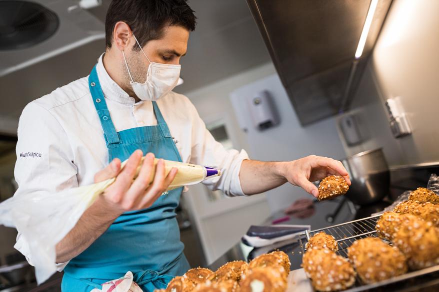 Pastry Chef Kevin Ollivier prepares some cabbage pastries with blueberries and wild thyme for the take-away meals at Auberge du Pere Bise on April 19, 2020 in Talloires, France. Two Michelin Star chef Jean Sulpice and his team are producing take-away meals for clients because of restaurant closures during France's lockdown.