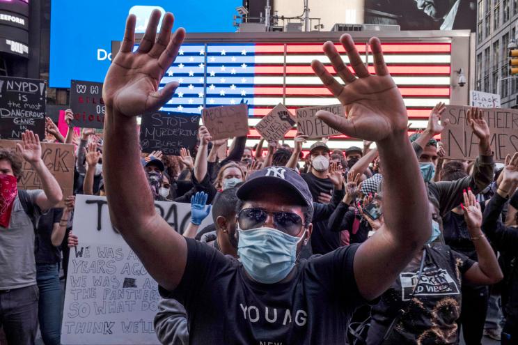 Protesters gather in New York City on Sunday to condemn the death of George Floyd while in police custody.