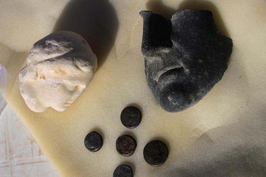 The alabaster head of a Queen Cleopatra statue, left, a part of a mask believed to belong to Mark Anthony, and coins bearing Cleopatra's image are displayed at the temple of Taposiris Magna, which was built during the reign of King Ptolemy II (282-246 B.C.), in Burg Al Arab west of Alexandria, Egypt.