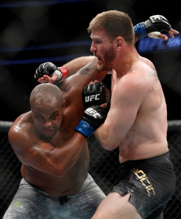 Daniel Cormier, left, and Stipe Miocic fight in 2018.