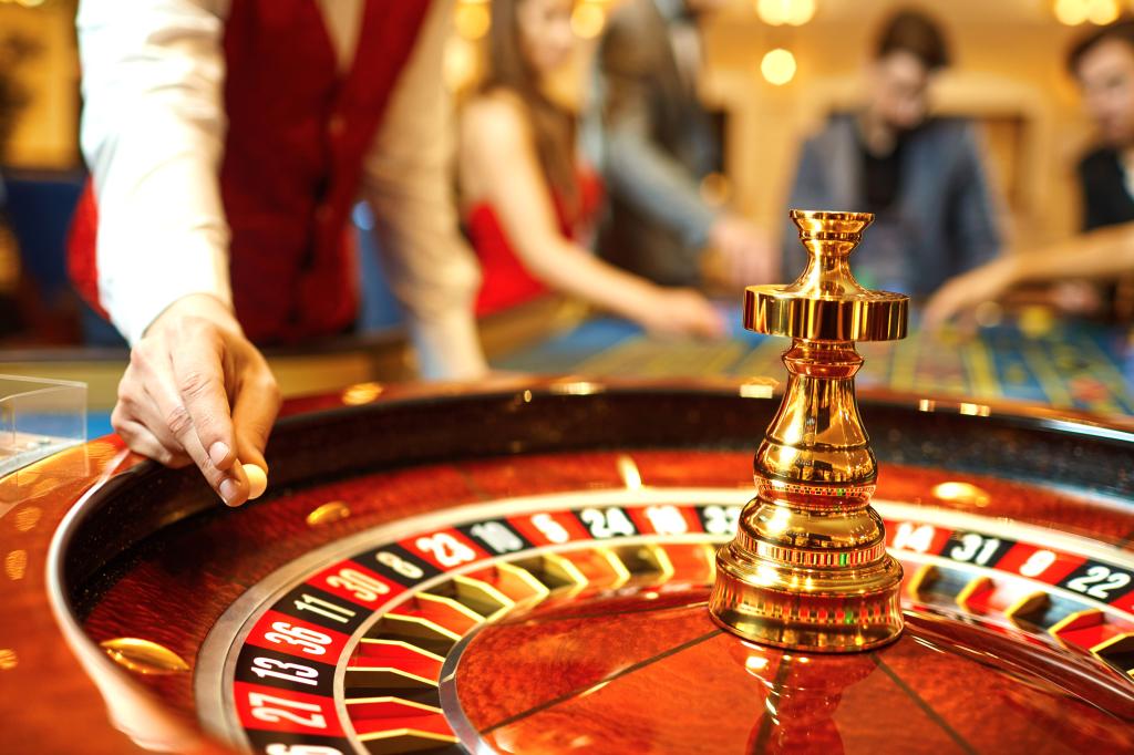 The croupier holds a roulette ball in a casino in his hand. Gambling in a casino.