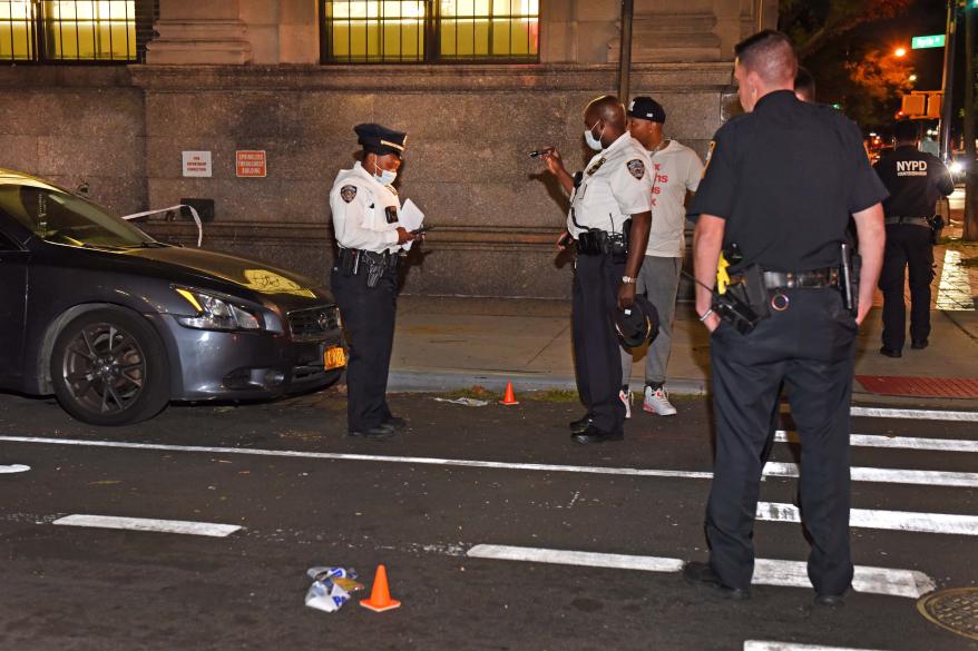 NYPD officers investigate at the crime scene.