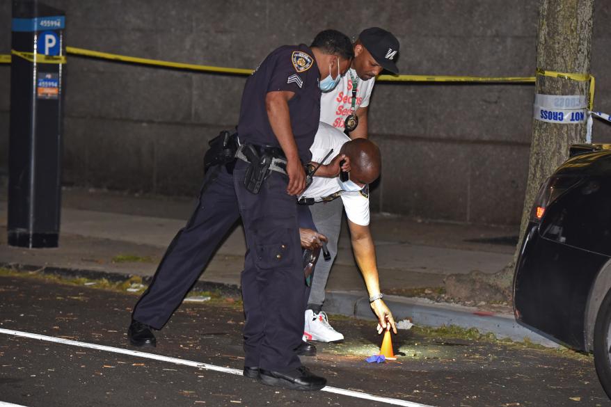 NYPD officers investigate at the crime scene.