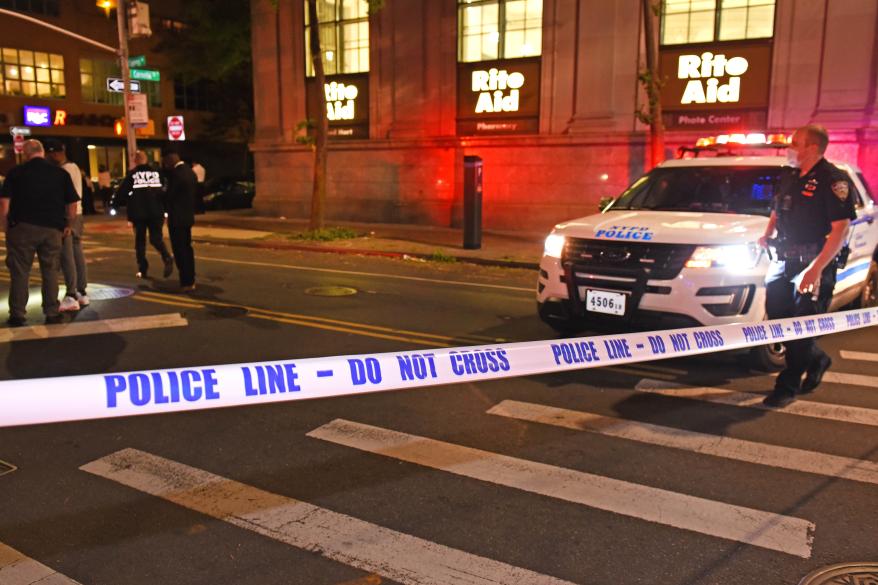 NYPD officers investigate at the crime scene.