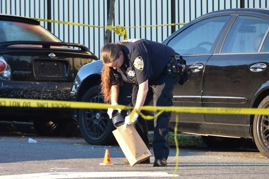 Officials at the scene of shooting In Jamaica, Queen today.