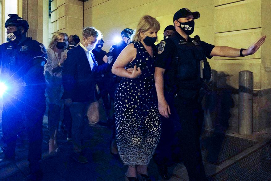 Sen. Rand Pau is escorted by police after attending President Trump's RNC acceptance speech at the White House last month.