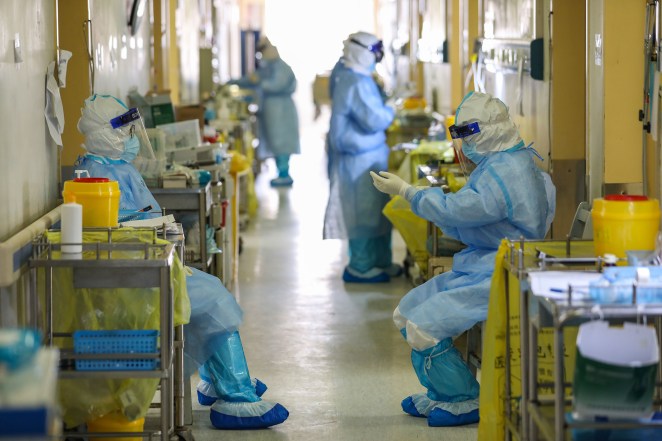 Medical staff waiting outside rooms at the Red Cross hospital in Wuhan.