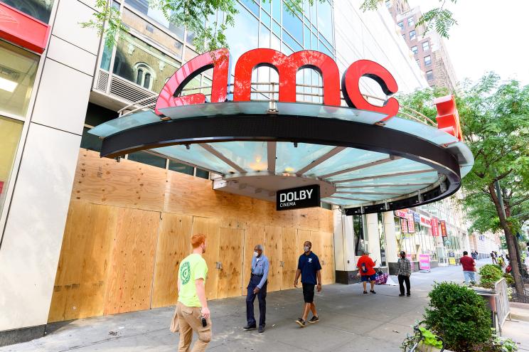 People walk outside the closed AMC 34th Street 14 movie theater in Manhattan last month.