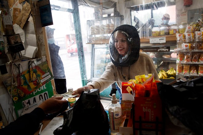 Hannah Frishberg wears a coronavirus protection helmet