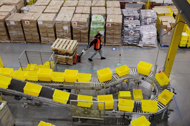 Amazon workers perform their jobs inside of an Amazon fulfillment center on Cyber Monday in Robbinsville, New Jersey